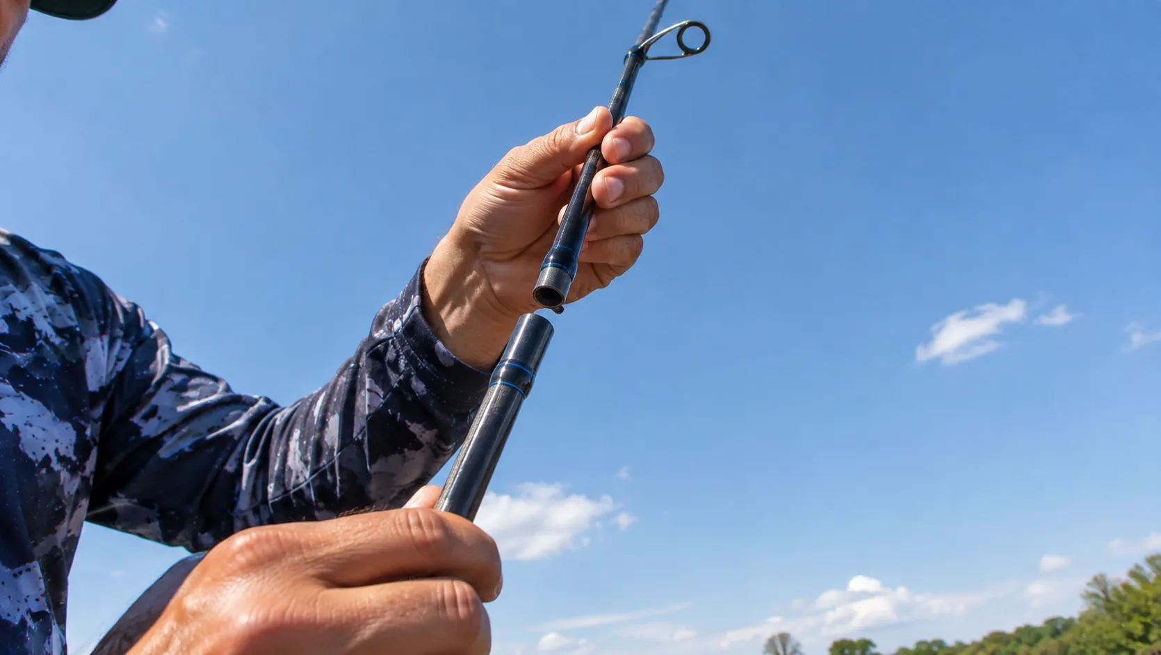 Como armar vara de pesca: mãos encaixando a ponteira das duas seções da vara